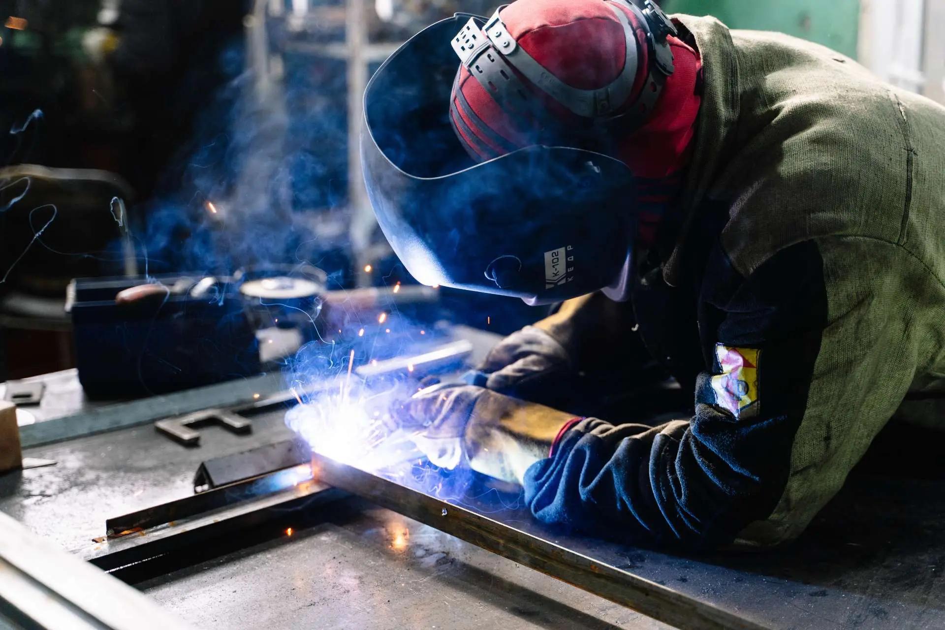 Professional Welder in a Factory Welding Steel Bars