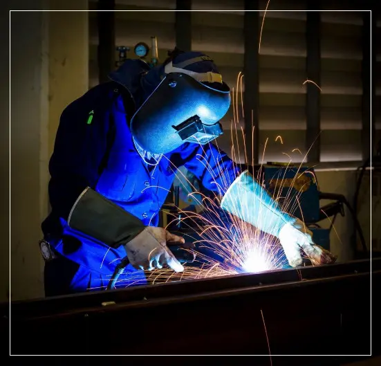 Worker With Protective Mask Welding Metal