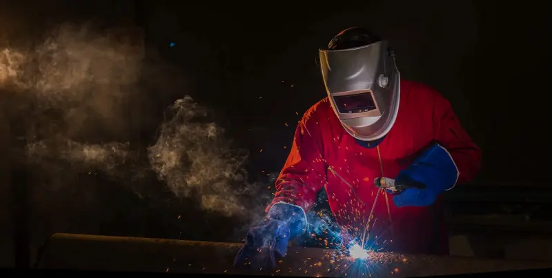 Workshop Welder in Red Uniform